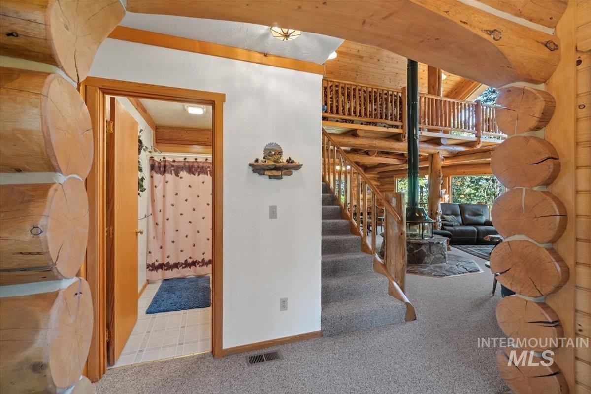 3725 Rim Road New Meadows, ID 83654 - Photo 3 of 50 Stairs featuring carpet floors and log walls