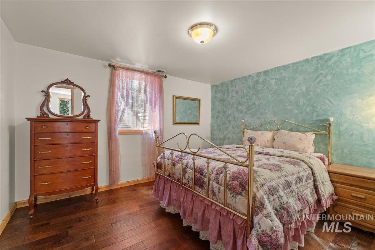 3725 Rim Road New Meadows, ID 83654 - Photo 37 of 50 Bedroom with dark wood-type flooring and wallpapered walls