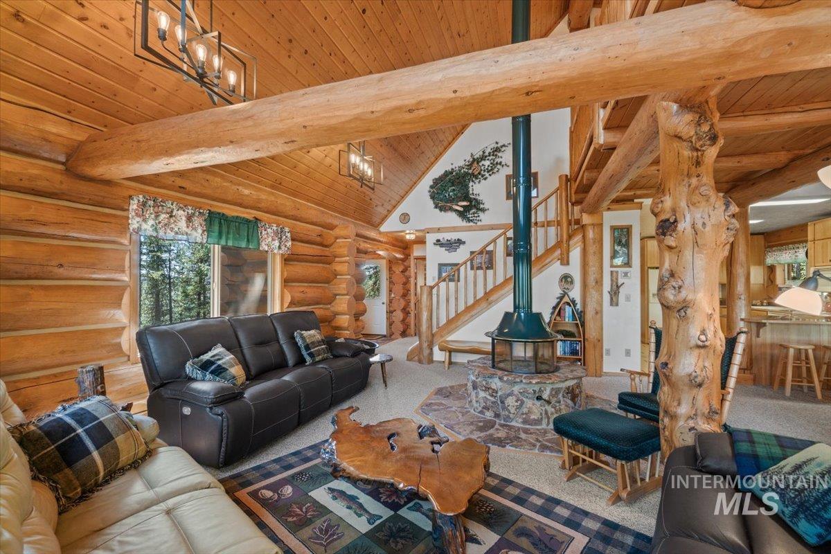 3725 Rim Road New Meadows, ID 83654 - Photo 5 of 50 Living room featuring a wooden ceiling with exposed beams, stairs, rustic walls, high vaulted ceiling, and carpet