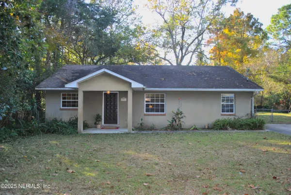 a front view of house with yard and trees