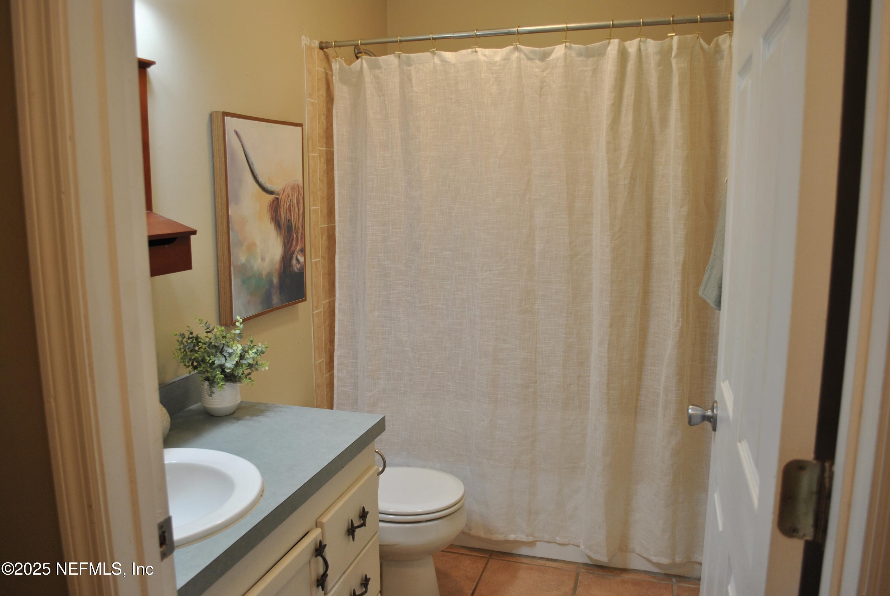 2819 North 6th Street St. Augustine, FL 32084 - Photo 13 of 18 a bathroom with a granite countertop sink and a mirror