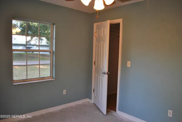 a view of an empty room with a window