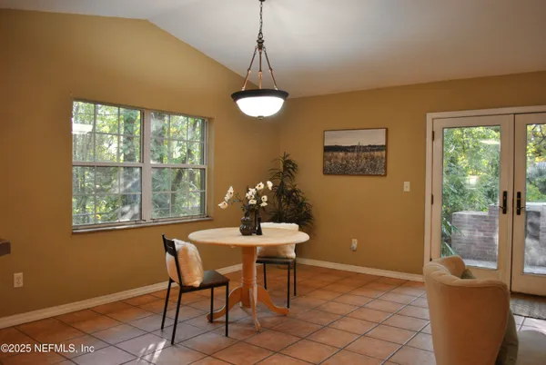 a dining room with furniture and window