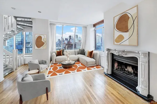 a living room with fireplace furniture and a large window