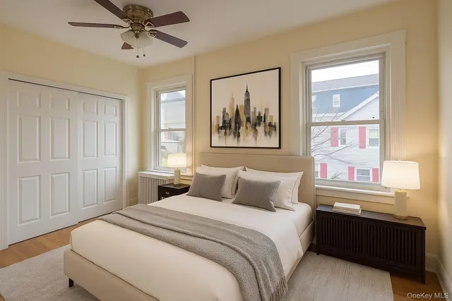 a bedroom with a bed and a painting on the wall