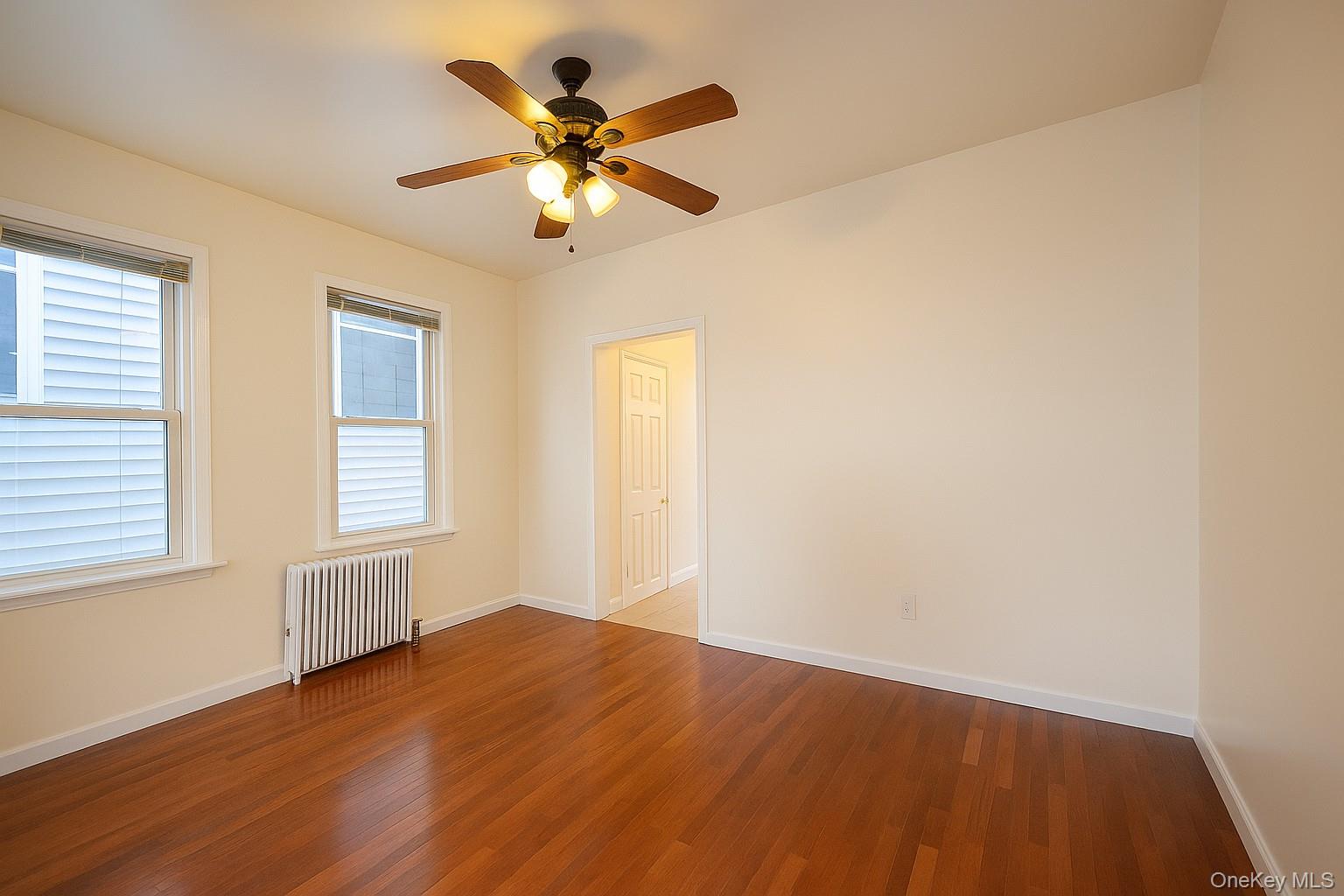 104 Livingston Avenue, Unit 2 Yonkers, NY 10705 - Photo 2 of 12 wooden floor in an empty room with a window
