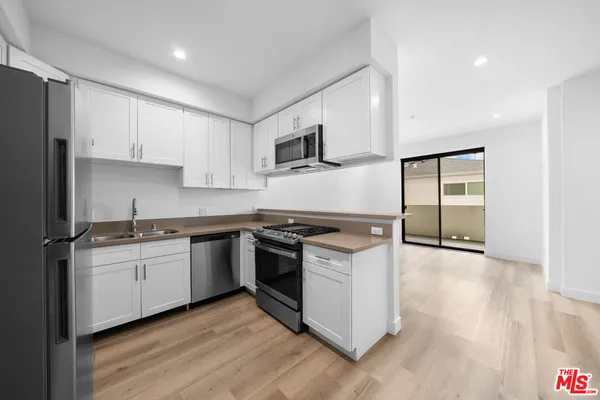 a kitchen with stainless steel appliances granite countertop a stove and a sink
