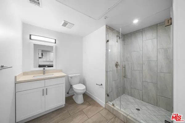 a bathroom with a toilet a sink and shower