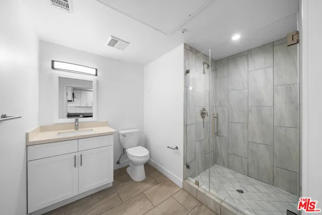 a bathroom with a toilet a sink and shower