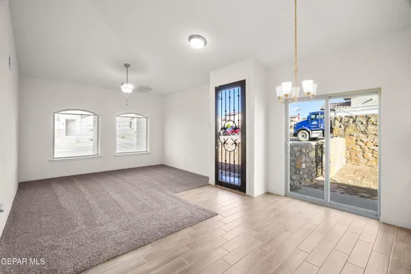 a view of kitchen with refrigerator and cabinets
