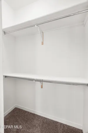 a bathroom with a granite countertop sink mirror vanity and toilet