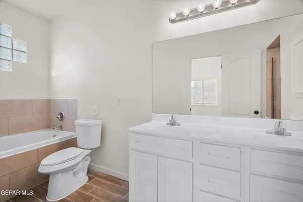 a bathroom with a sink vanity and a mirror