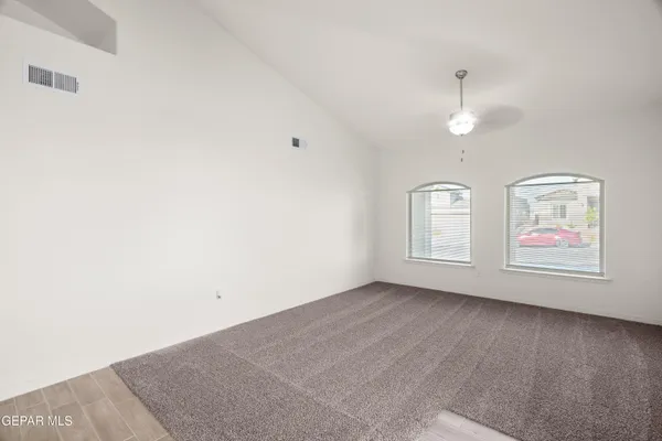 a open kitchen with stainless steel appliances granite countertop a refrigerator a sink a stove and a wooden floor