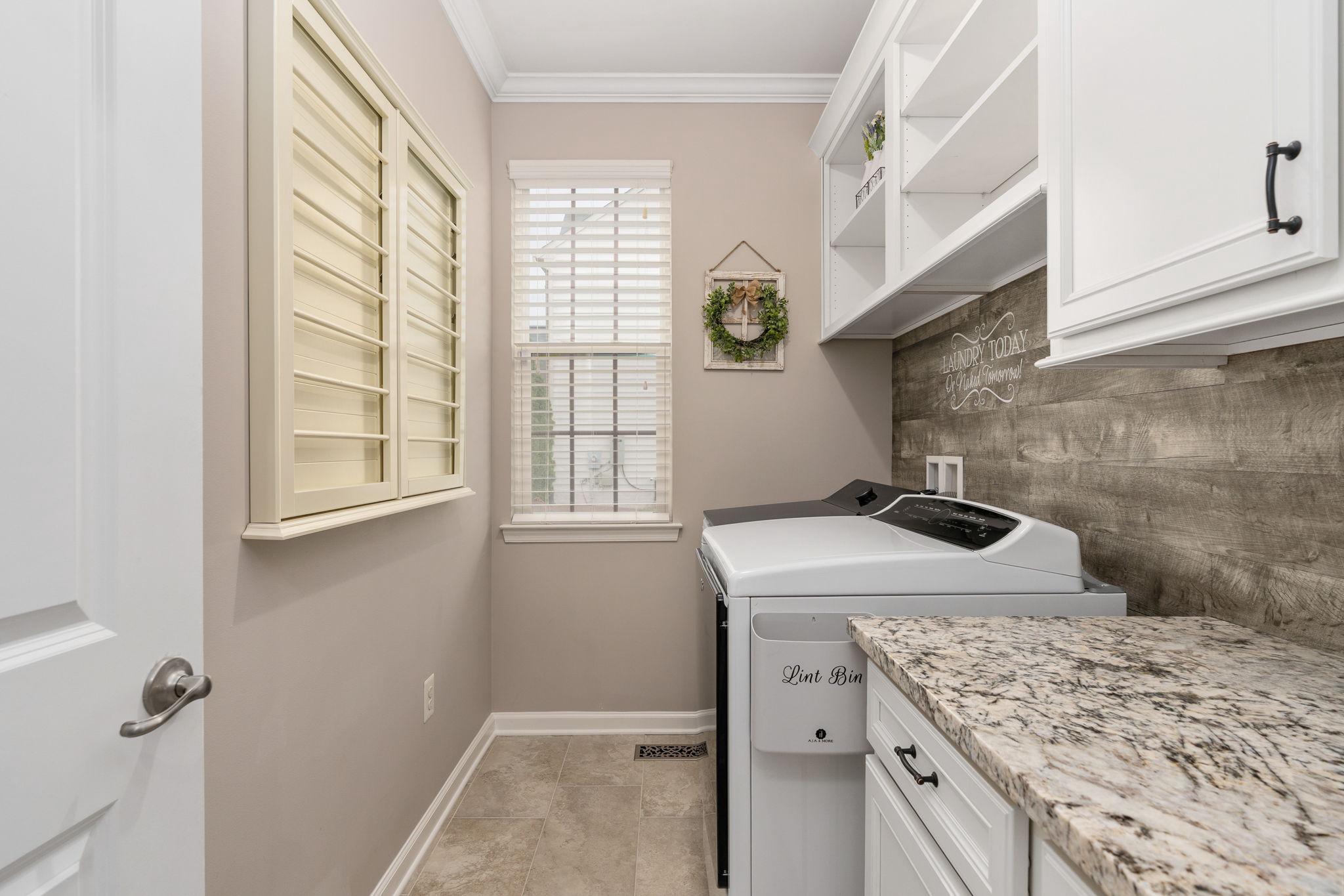 9417 Reservoir Road Fredericksburg, VA 22407 - Photo 29 of 76 a bathroom with a sink and washing machine