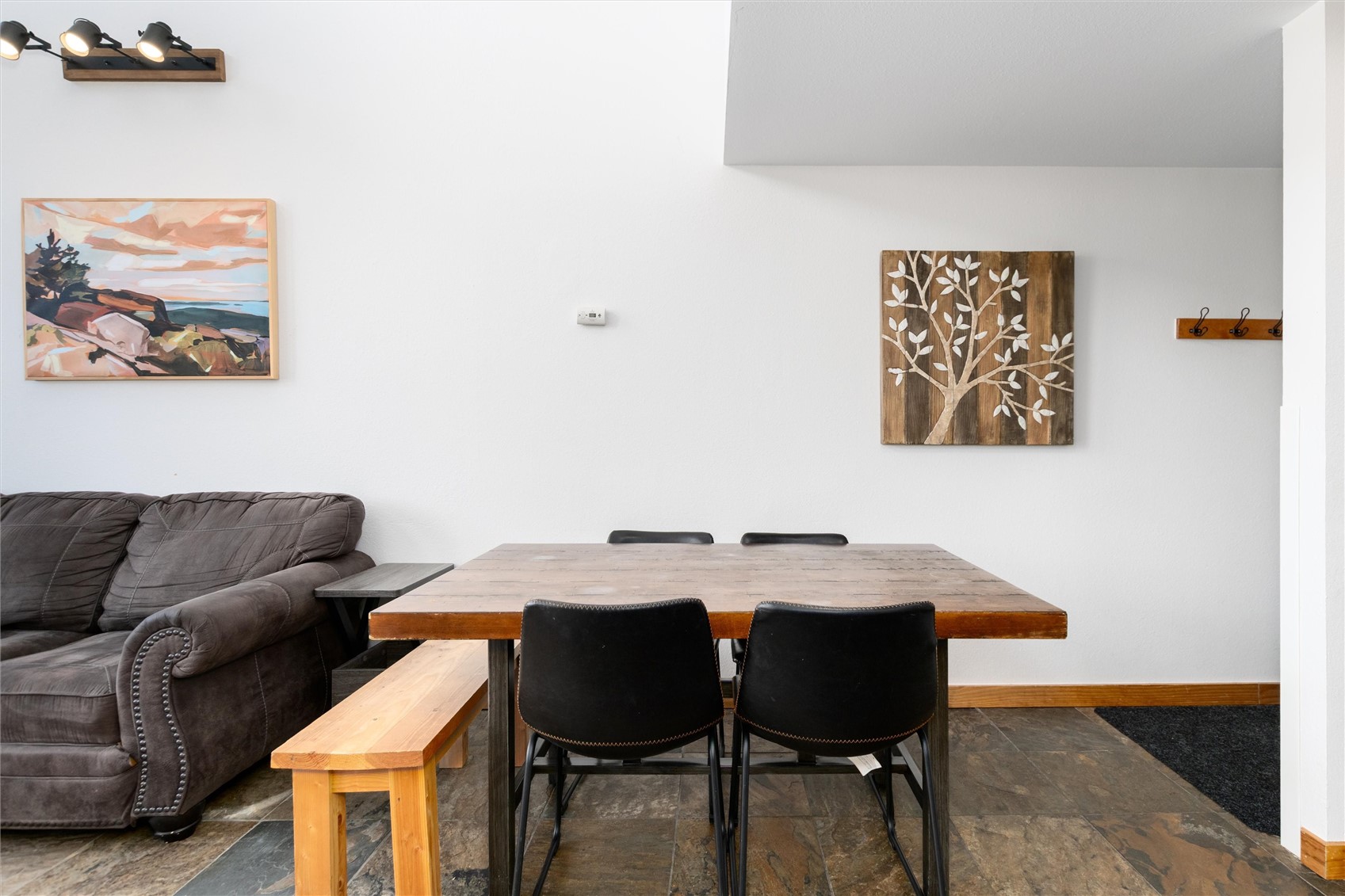 22340 Highway 6, Unit 1804 Keystone, CO 80435 - Photo 13 of 49 a view of a dining room with furniture and wooden floor