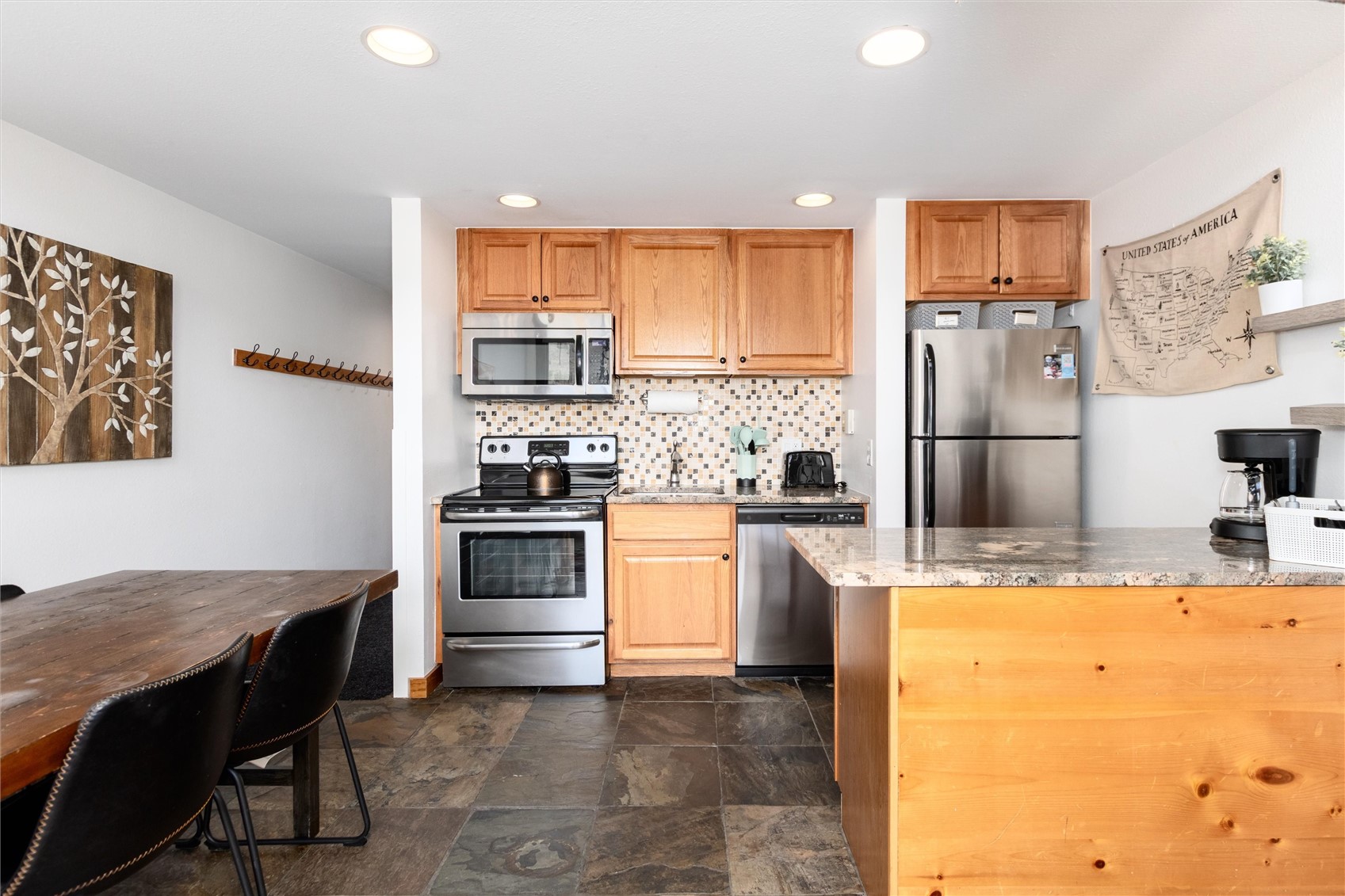 22340 Highway 6, Unit 1804 Keystone, CO 80435 - Photo 15 of 49 a kitchen with a stove a refrigerator and a dining table