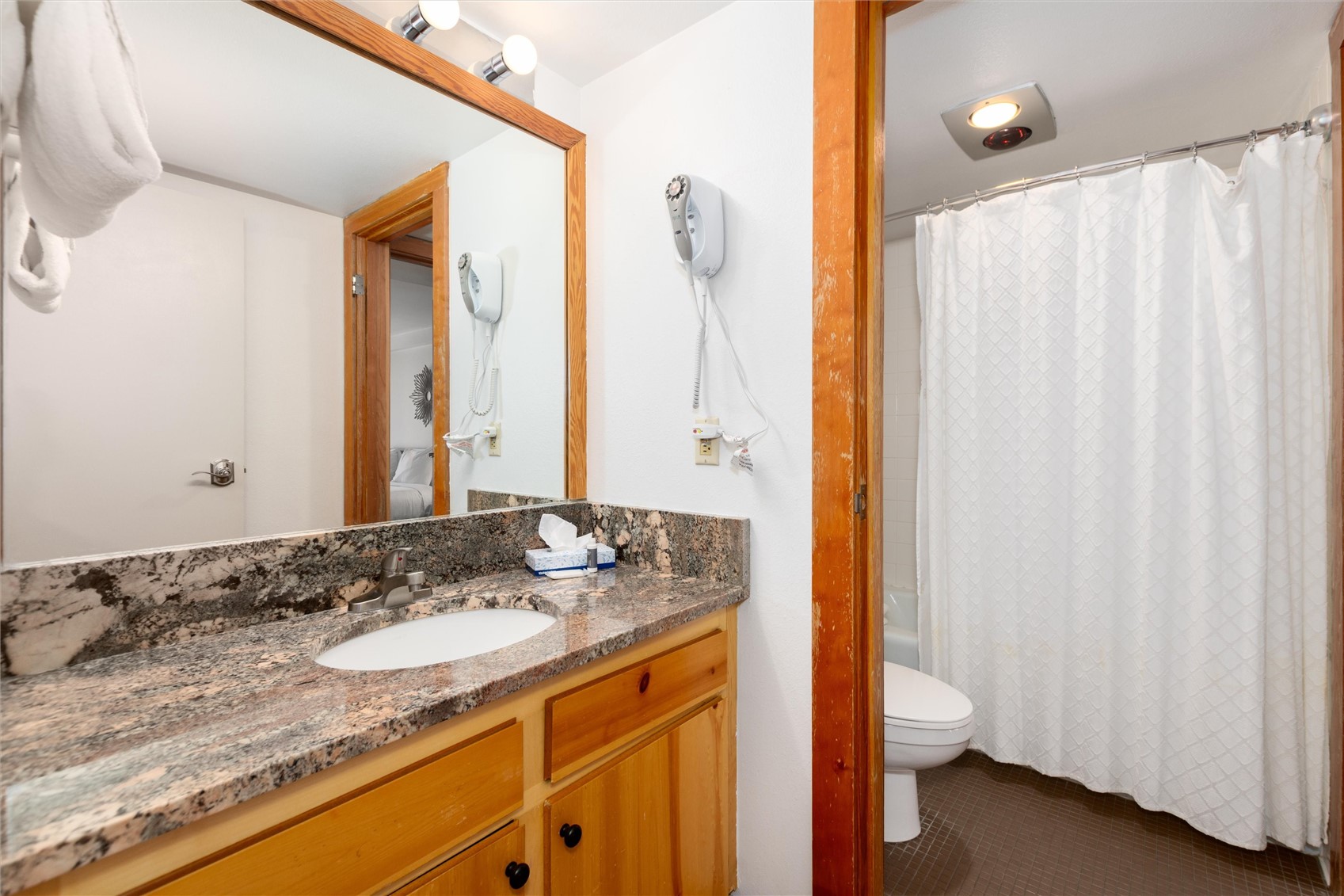 22340 Highway 6, Unit 1804 Keystone, CO 80435 - Photo 28 of 49 a bathroom with a granite countertop sink and a mirror