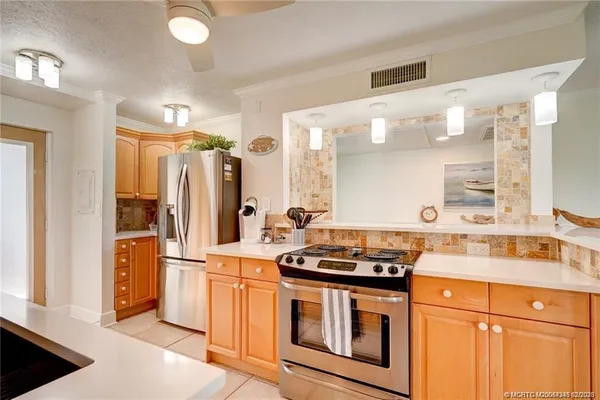 a kitchen with stainless steel appliances a stove sink and refrigerator