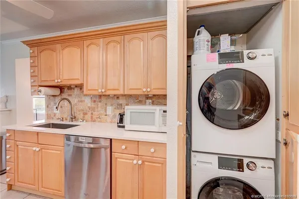 a kitchen with a sink a stove and cabinets