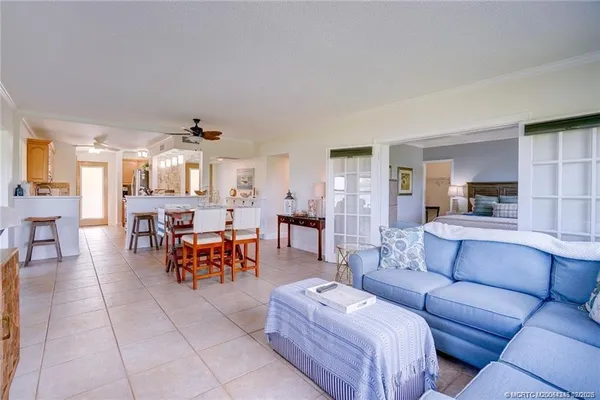a living room with furniture and kitchen view
