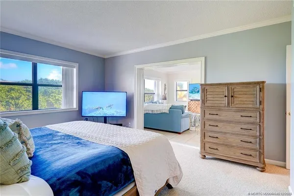 a bedroom with a bed and dresser