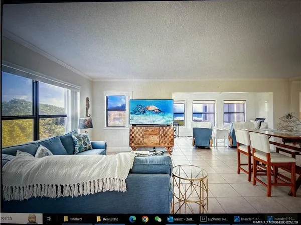 a bedroom with furniture and a large window