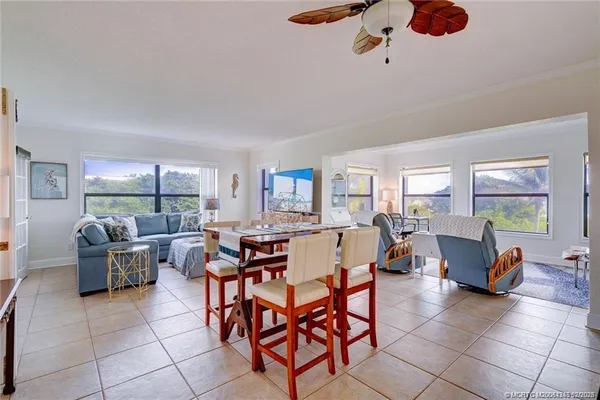 a living room with fireplace furniture and a large window