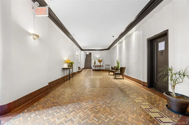 a view of empty room with wooden floor and windows