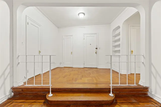 a view of a room with an empty space and wooden floor
