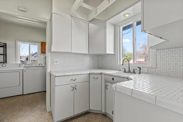 a view of a kitchen with sink and cabinets