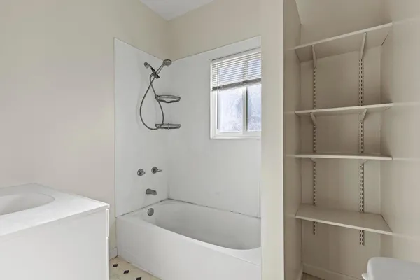 a bathroom with a bathtub and a shower