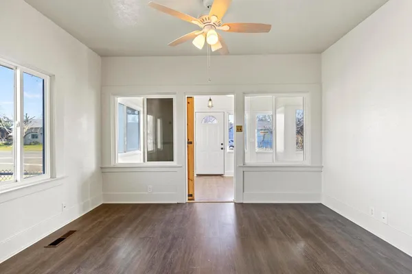wooden floor in an empty room with a window