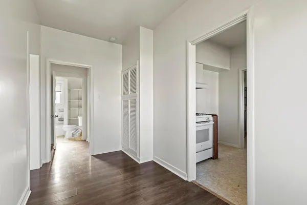 a view of a hallway with wooden floor