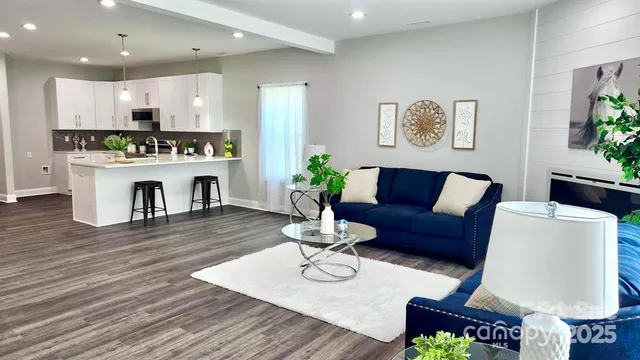 a living room with furniture kitchen and a table