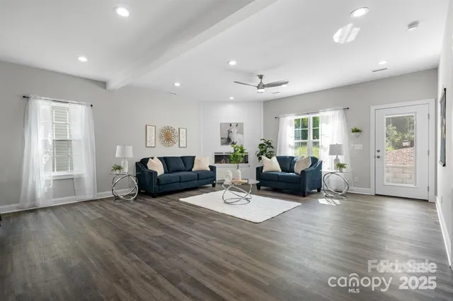 a living room with furniture and wooden floor