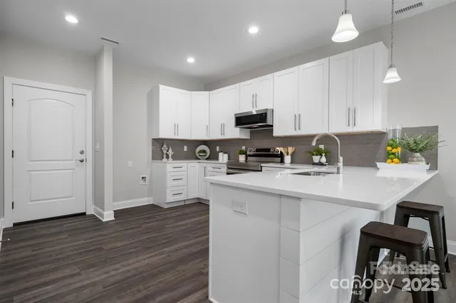a kitchen with a sink window and cabinets