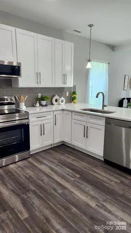 a large kitchen with cabinets and stainless steel appliances