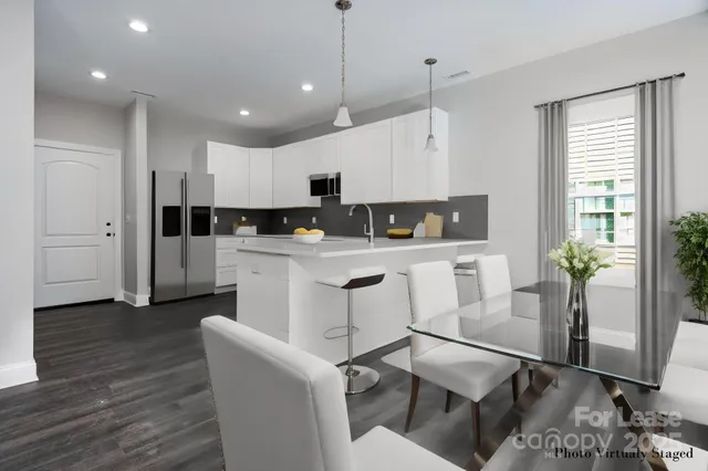 a kitchen with white cabinets and counter space
