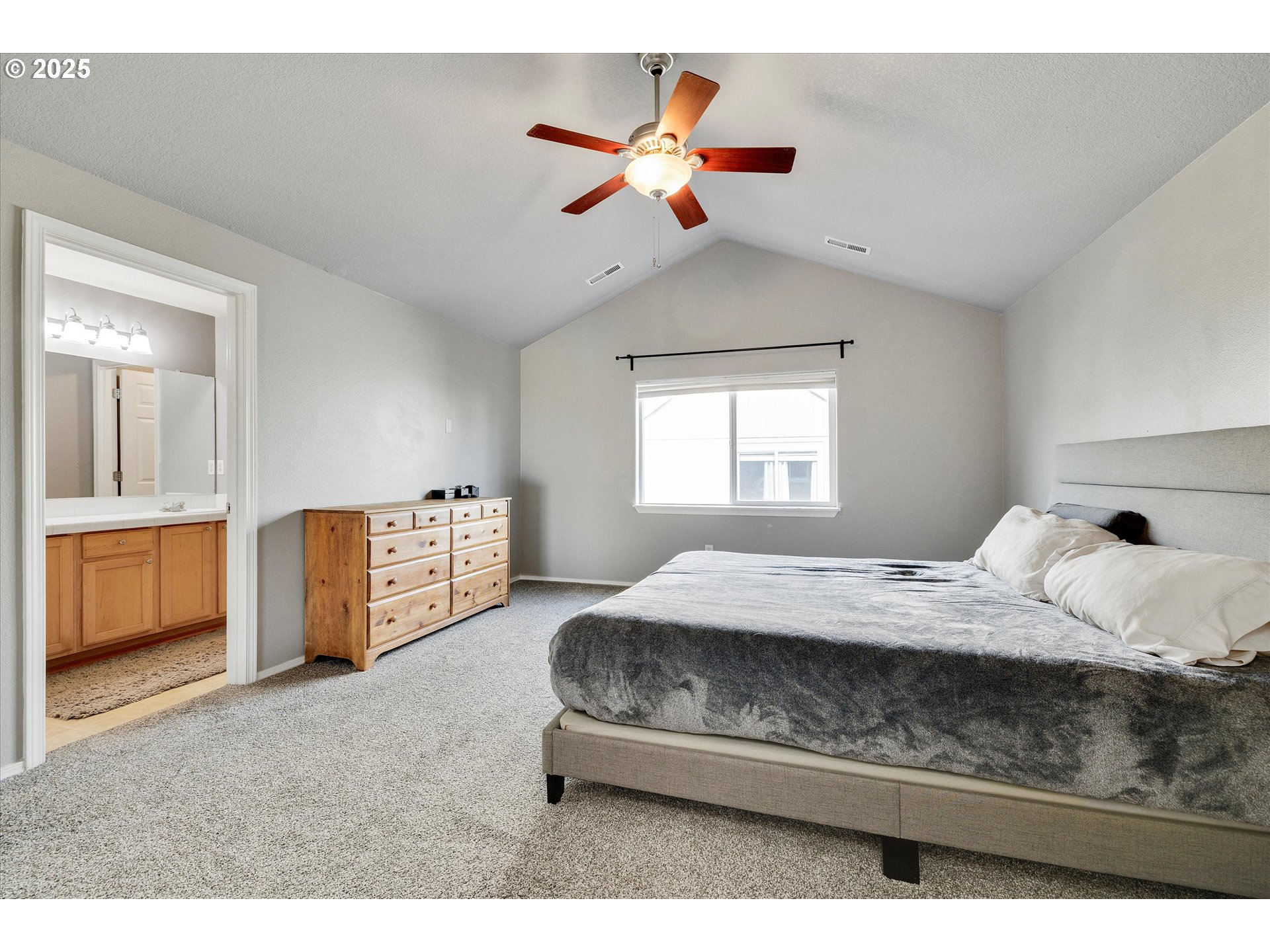 17645 Southwest Jay Street Beaverton, OR 97003 - Photo 17 of 31 a bedroom with a bed and a chandelier