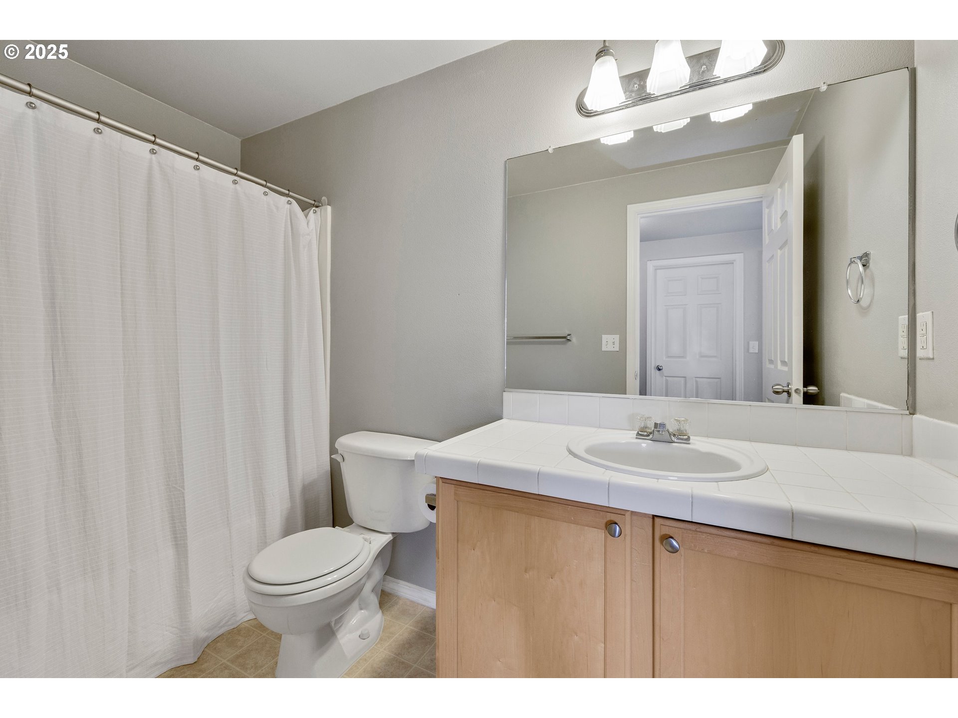 17645 Southwest Jay Street Beaverton, OR 97003 - Photo 25 of 31 a bathroom with a sink a toilet and mirror