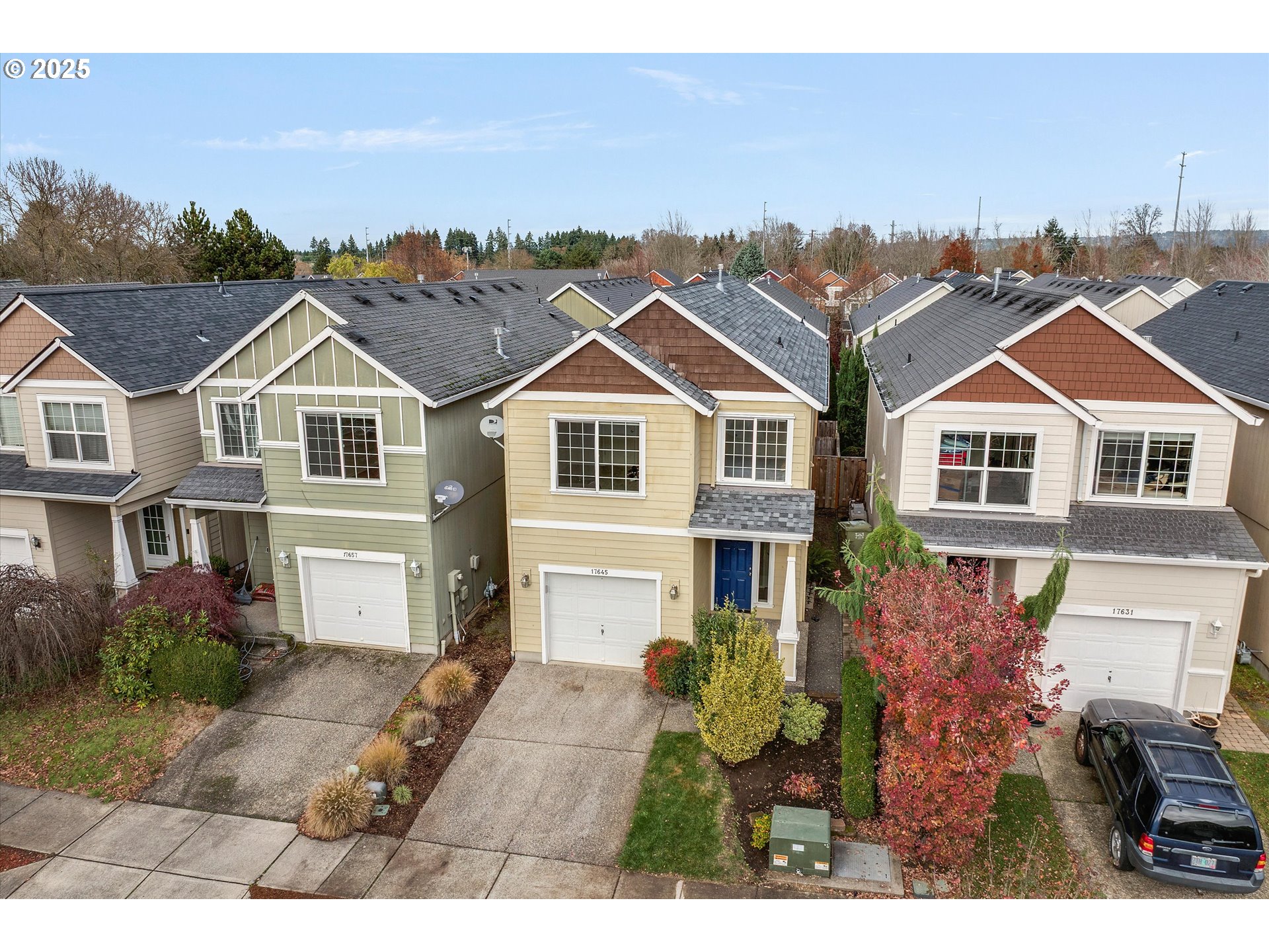 17645 Southwest Jay Street Beaverton, OR 97003 - Photo 31 of 31 a view of a white house next to a yard with potted plants