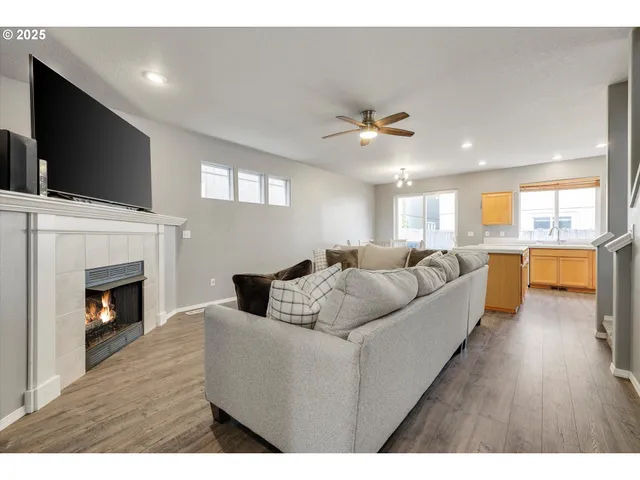 a living room with furniture fireplace and flat screen tv