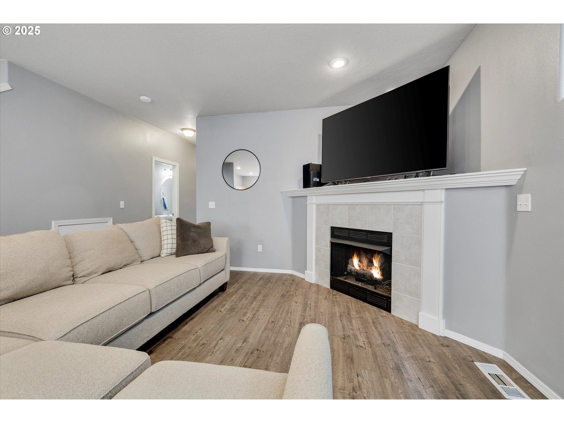 17645 Southwest Jay Street Beaverton, OR 97003 - Photo 9 of 31 a living room with a flat screen tv and a fireplace