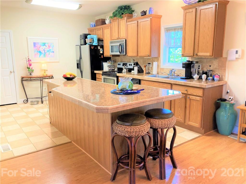 1821 Cove Road Rutherfordton, NC 28139 - Photo 3 of 46 a kitchen with appliances a sink and cabinets