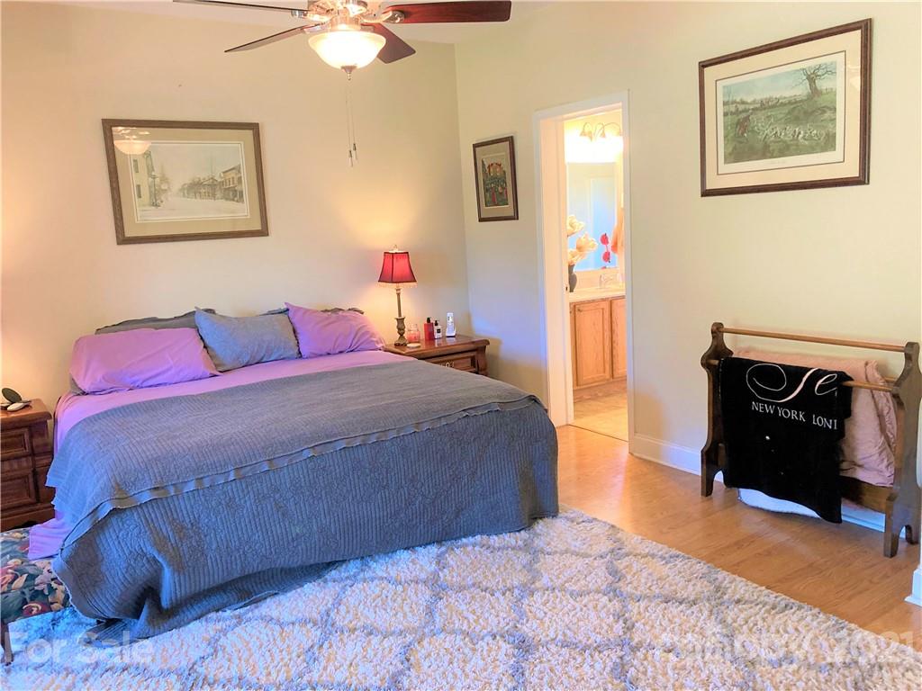 1821 Cove Road Rutherfordton, NC 28139 - Photo 22 of 46 a bedroom with a bed and a chandelier