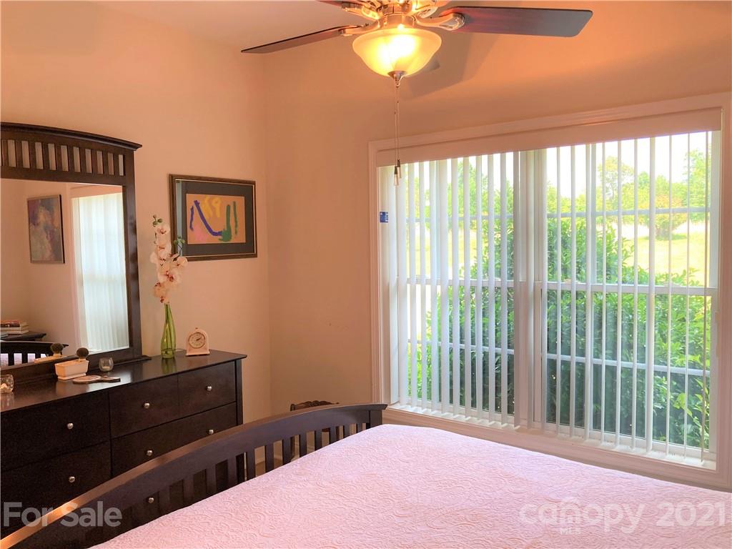 1821 Cove Road Rutherfordton, NC 28139 - Photo 26 of 46 a bedroom with a bed and a chandelier