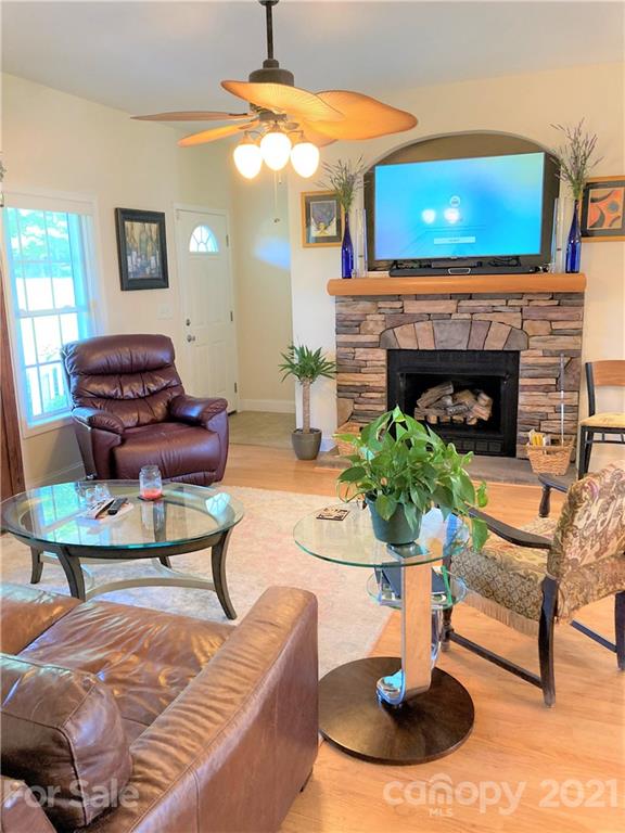1821 Cove Road Rutherfordton, NC 28139 - Photo 9 of 46 a living room with furniture a fireplace and a flat screen tv