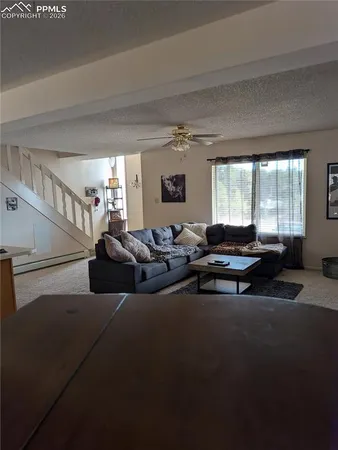 a view of a livingroom with furniture and a window