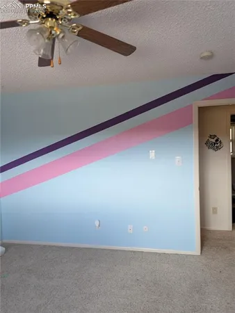 a backyard of a house with fire pit and trees