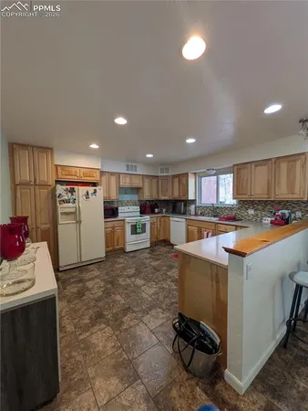 a kitchen with stainless steel appliances kitchen island granite countertop a sink and cabinets